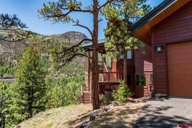 view of side of home featuring a mountain view and a garage