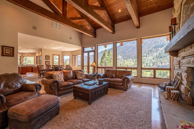 living room featuring beamed ceiling, hardwood / wood-style flooring, high vaulted ceiling, and wood ceiling