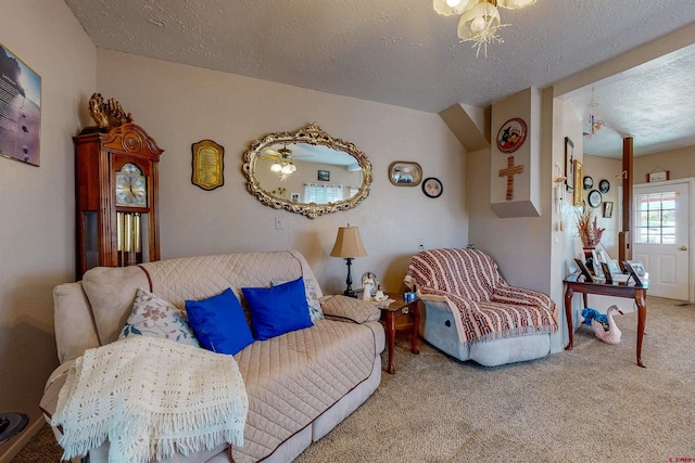 living room featuring a textured ceiling, light colored carpet, and ceiling fan