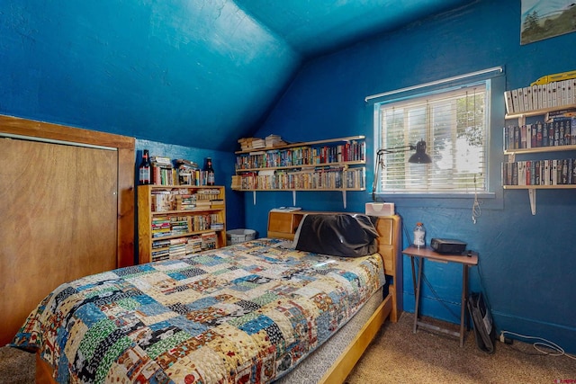 bedroom with a closet, carpet floors, and vaulted ceiling