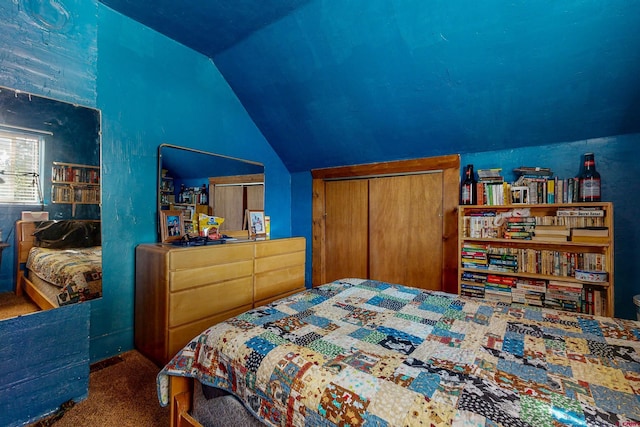 bedroom featuring carpet flooring, vaulted ceiling, and a closet