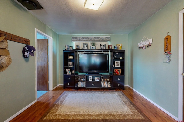 living room with wood-type flooring and a textured ceiling