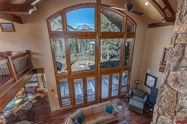 living room with beam ceiling, ceiling fan, french doors, dark wood-type flooring, and high vaulted ceiling