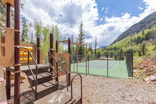 view of tennis court with a mountain view