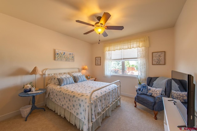 bedroom featuring light carpet and ceiling fan