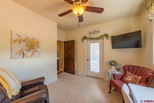 sitting room featuring ceiling fan and light colored carpet