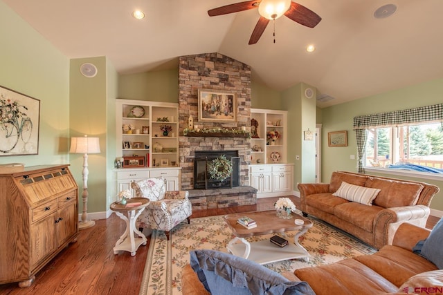 living room with ceiling fan, a fireplace, hardwood / wood-style floors, and vaulted ceiling