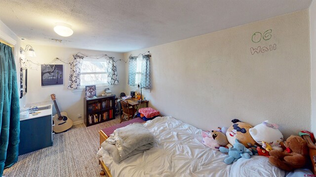 carpeted bedroom with a textured ceiling