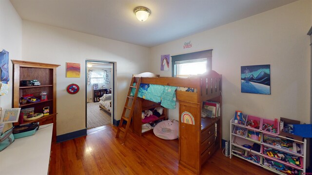 bedroom with dark hardwood / wood-style floors