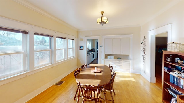 dining area with plenty of natural light and light hardwood / wood-style floors