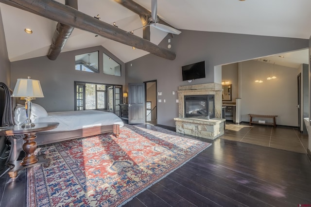 bedroom featuring beam ceiling, a stone fireplace, high vaulted ceiling, and dark wood-type flooring