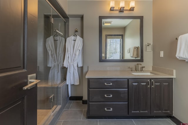 bathroom featuring tile patterned flooring, vanity, and an enclosed shower