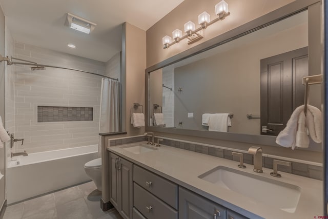 full bathroom featuring tile patterned floors, vanity, toilet, and shower / bath combo with shower curtain