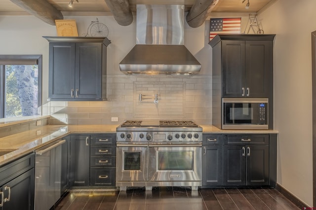 kitchen featuring dark wood-type flooring, stainless steel appliances, wall chimney range hood, beamed ceiling, and decorative backsplash