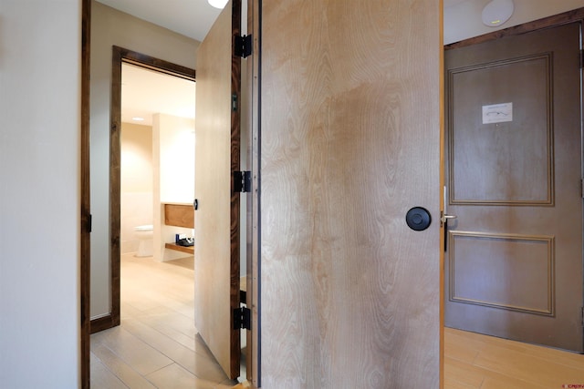 bathroom with hardwood / wood-style flooring and toilet