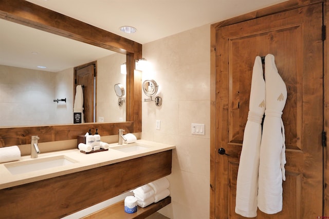 bathroom featuring beamed ceiling, vanity, and tile walls