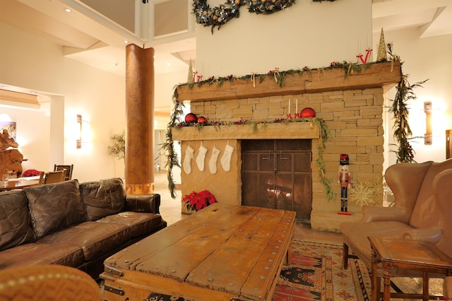 living area featuring a fireplace and a high ceiling