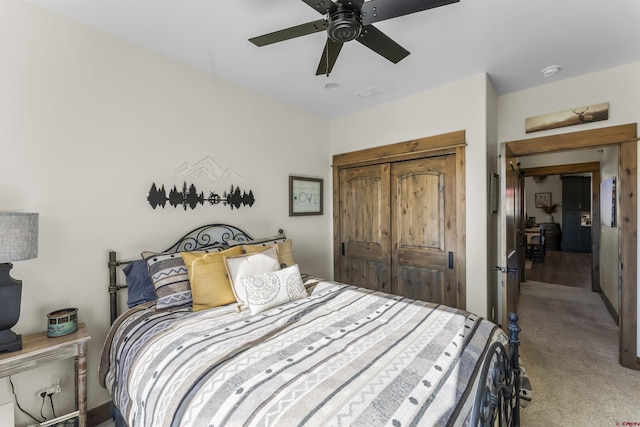 bedroom featuring ceiling fan, a closet, and carpet floors