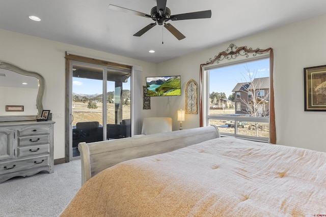 carpeted bedroom featuring access to exterior, multiple windows, and ceiling fan