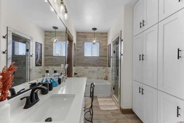 bathroom with vanity, wood-type flooring, and shower with separate bathtub