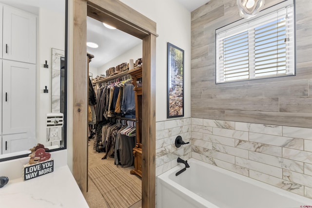 bathroom with a tub to relax in