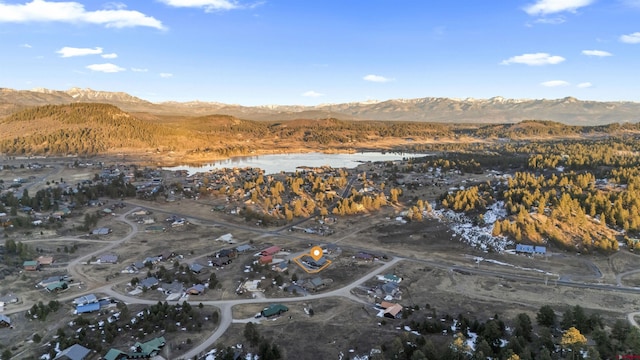 birds eye view of property featuring a water and mountain view