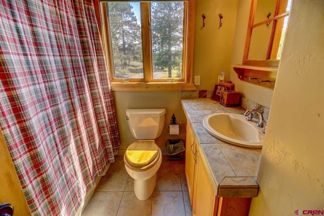 bathroom featuring vanity, toilet, and tile patterned floors