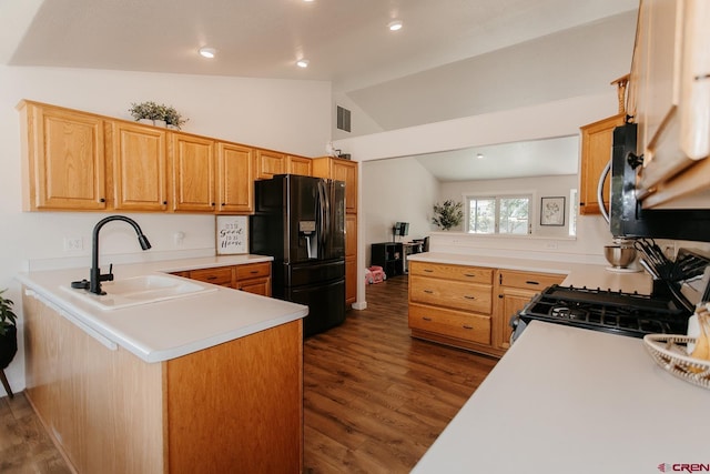 kitchen with black appliances, sink, vaulted ceiling, dark hardwood / wood-style floors, and kitchen peninsula