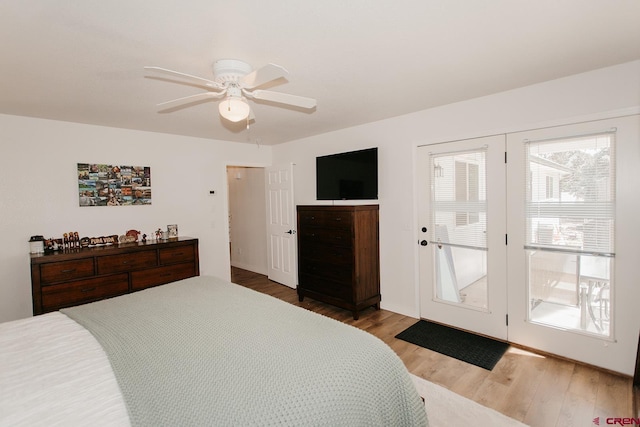 bedroom with access to outside, hardwood / wood-style flooring, and ceiling fan