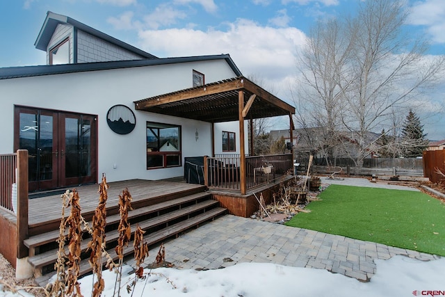 back of property featuring a lawn, a pergola, a wooden deck, and french doors