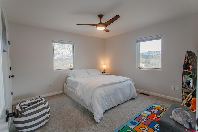 bedroom featuring light colored carpet and ceiling fan