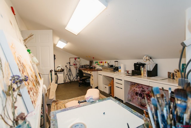 additional living space featuring built in desk, lofted ceiling, and carpet floors