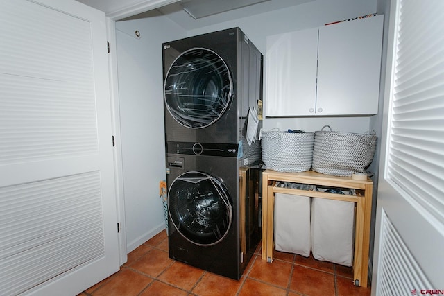 laundry area with tile patterned floors and stacked washer / drying machine