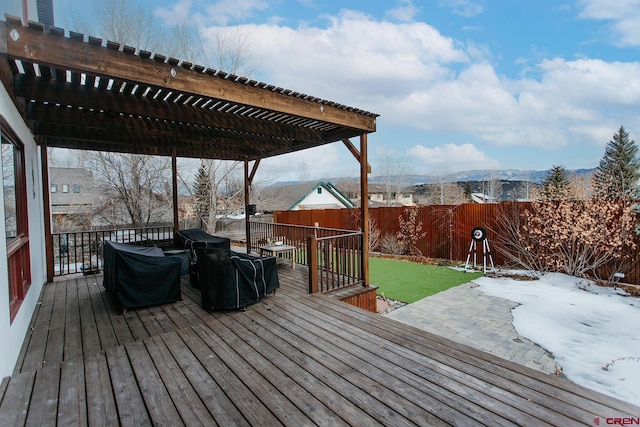 wooden terrace with a lawn, a mountain view, and a pergola