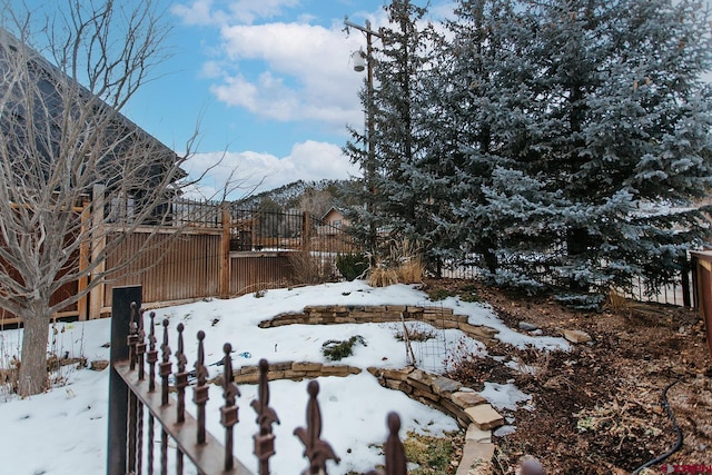 snowy yard with a wooden deck