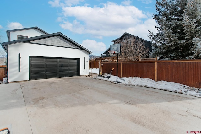 snow covered property featuring an outdoor structure