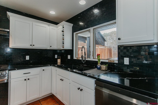 kitchen with dishwasher, sink, tasteful backsplash, tile patterned floors, and white cabinets