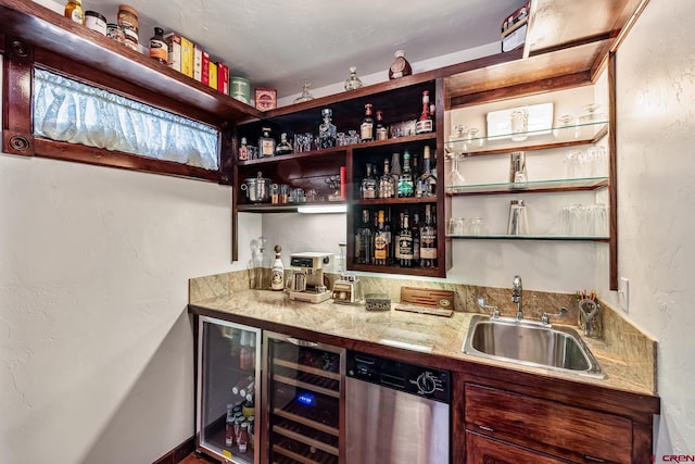 bar with light stone counters, sink, and stainless steel dishwasher