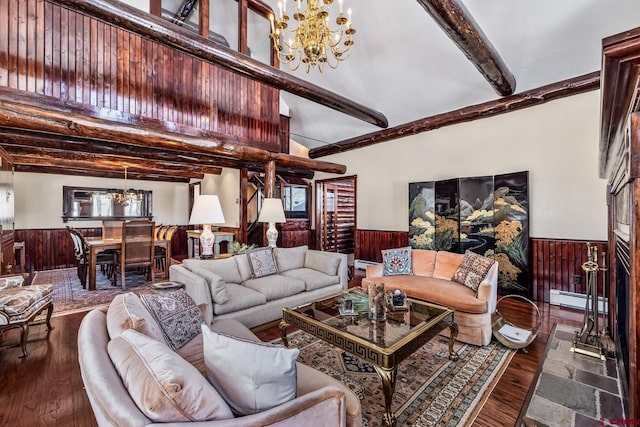 living room with an inviting chandelier, baseboard heating, beamed ceiling, dark hardwood / wood-style floors, and wooden walls