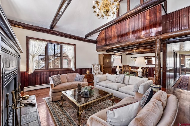 living room with wood walls, dark hardwood / wood-style floors, baseboard heating, beamed ceiling, and a notable chandelier