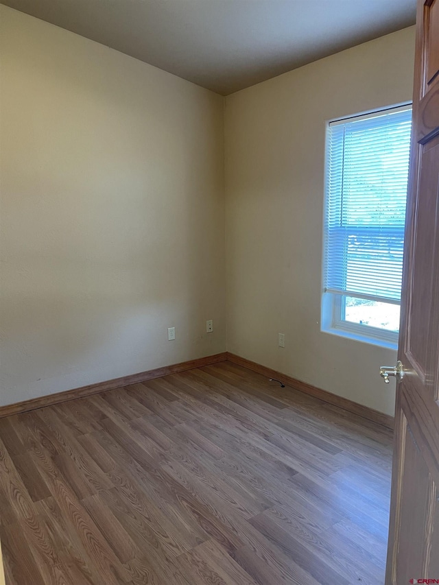 empty room with light hardwood / wood-style flooring