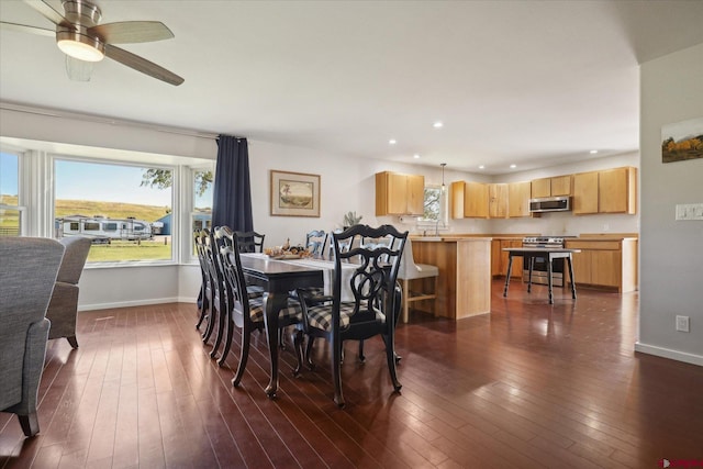 dining room featuring ceiling fan and dark hardwood / wood-style flooring