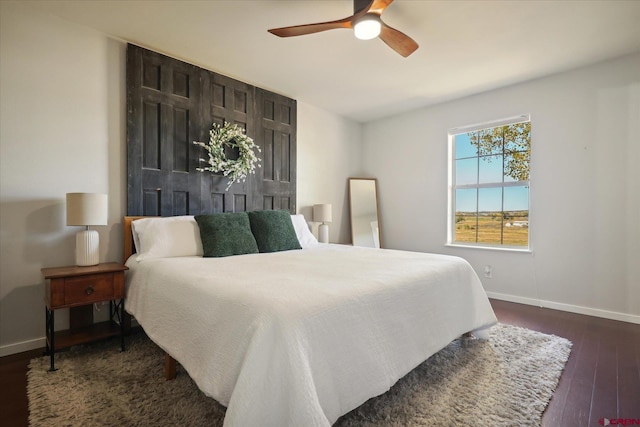 bedroom with ceiling fan and dark wood-type flooring