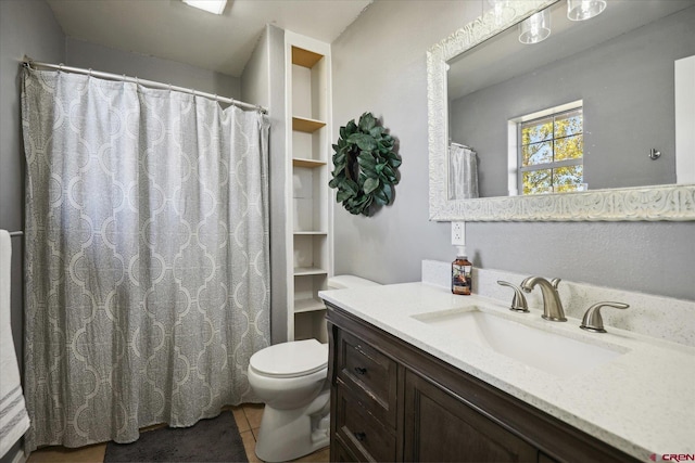 bathroom featuring tile patterned floors, built in features, vanity, and toilet