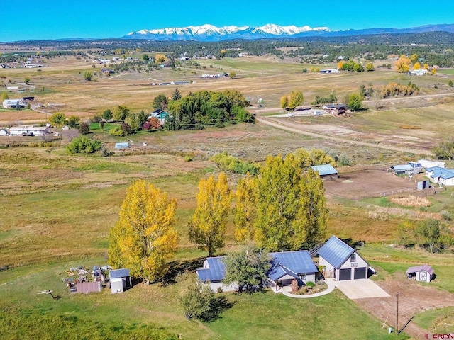 birds eye view of property with a mountain view and a rural view