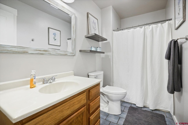 bathroom featuring tile patterned floors, vanity, and toilet