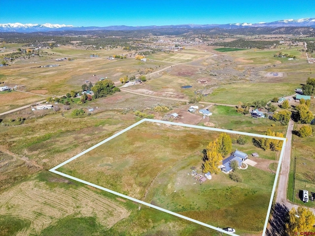 drone / aerial view featuring a mountain view and a rural view