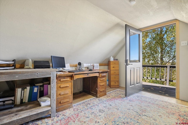 office area with a healthy amount of sunlight, a textured ceiling, and vaulted ceiling