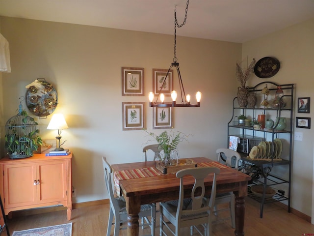 dining space featuring a chandelier and hardwood / wood-style floors