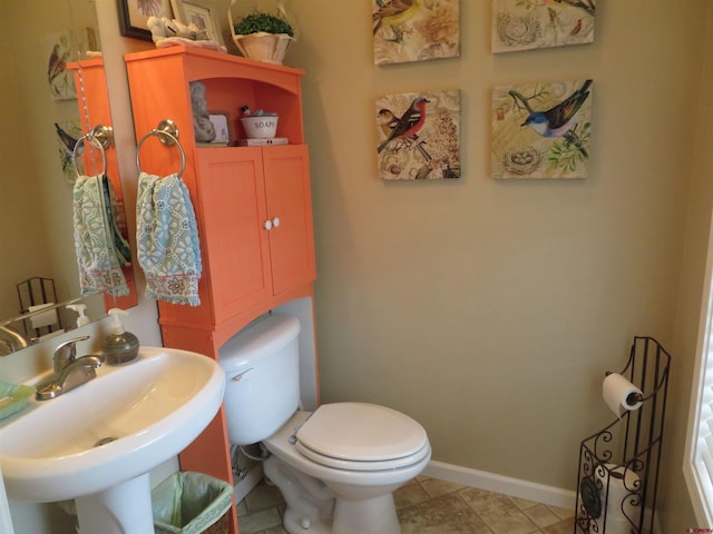 bathroom with tile patterned flooring, toilet, and sink